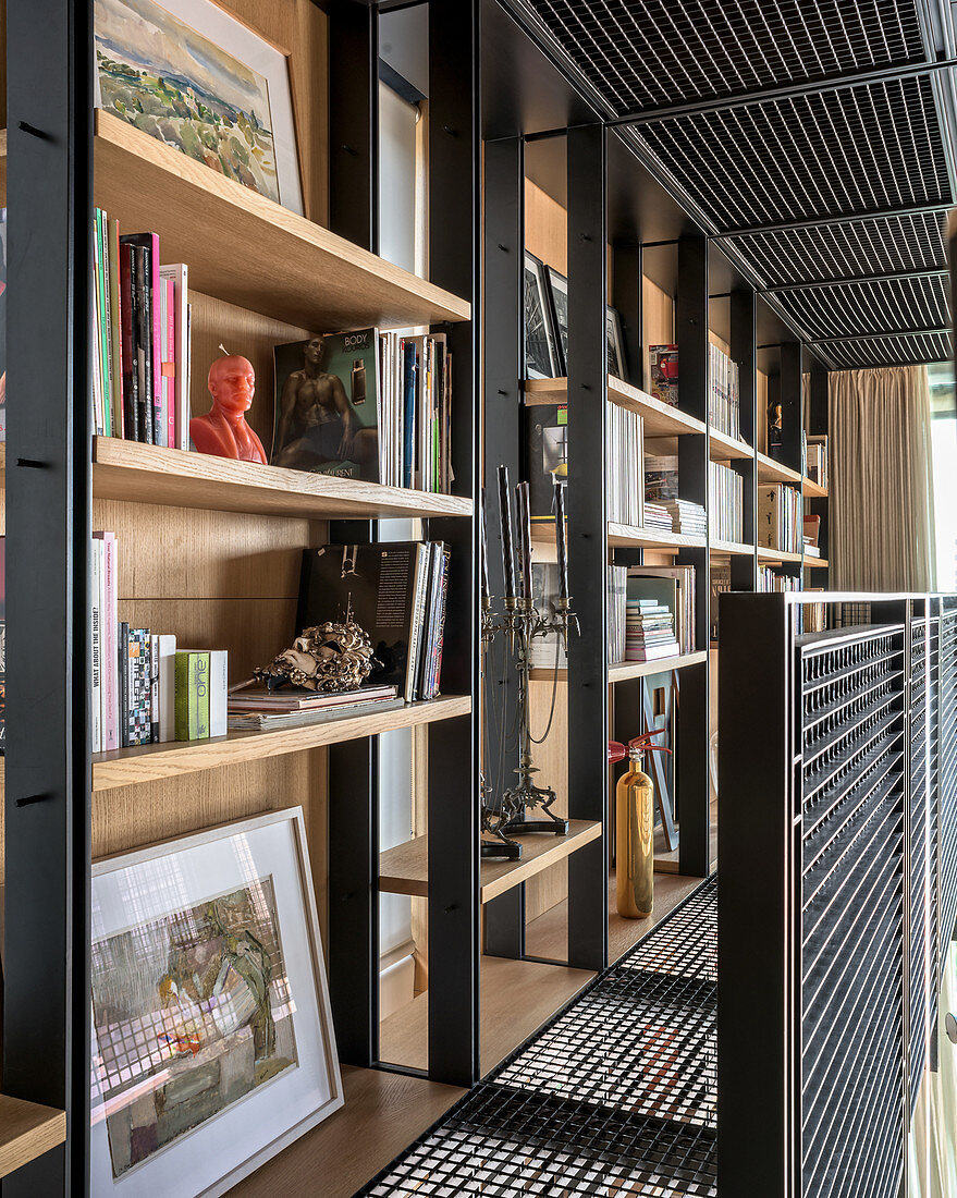 Bookcases on gallery made from black wire mesh