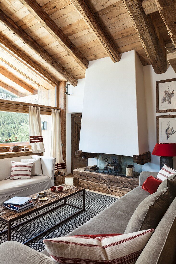 Wood-beamed ceiling and fireplace in rustic living room