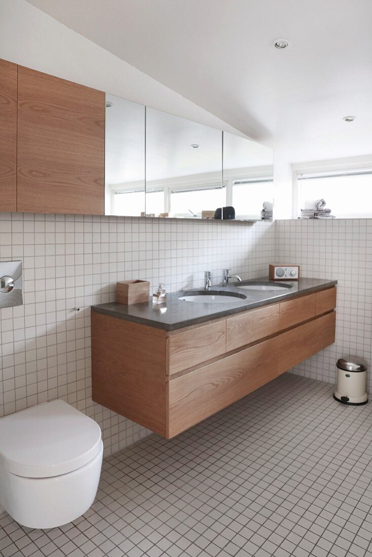 Bright bathroom with white tiles and fitted furnishings