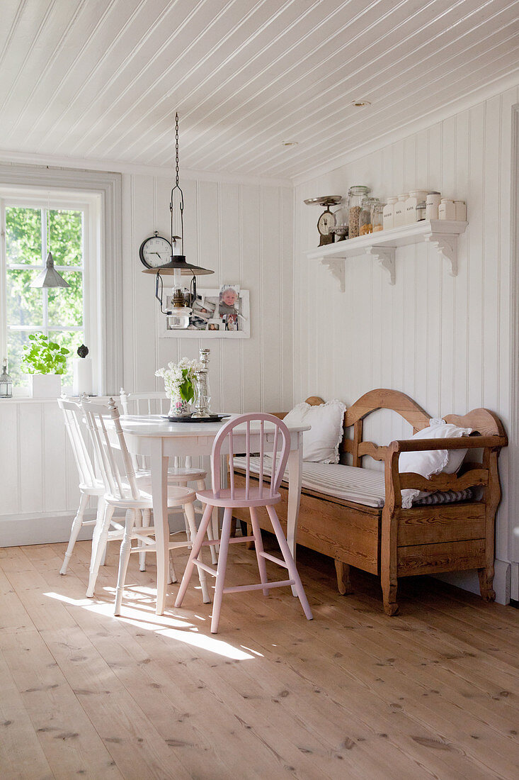 Country-house-style dining room with wood-clad walls