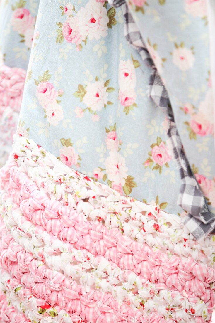 Floral blanket with crocheted, rag-yarn edge