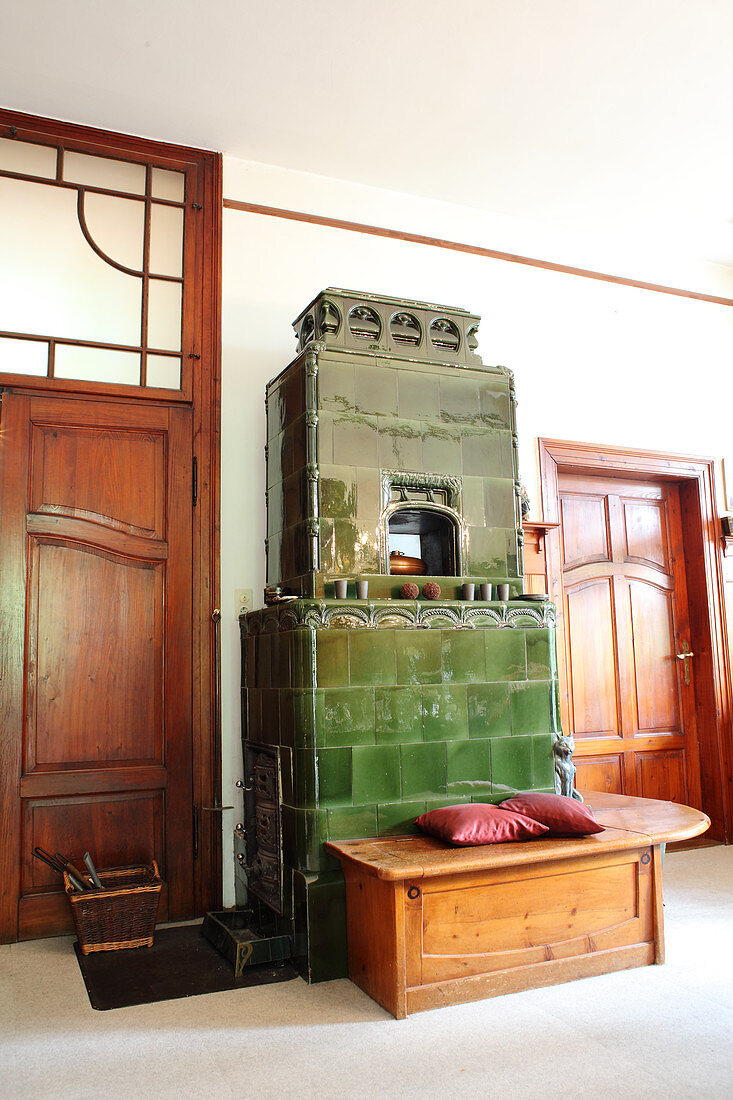 Green tiled stove with wooden bench