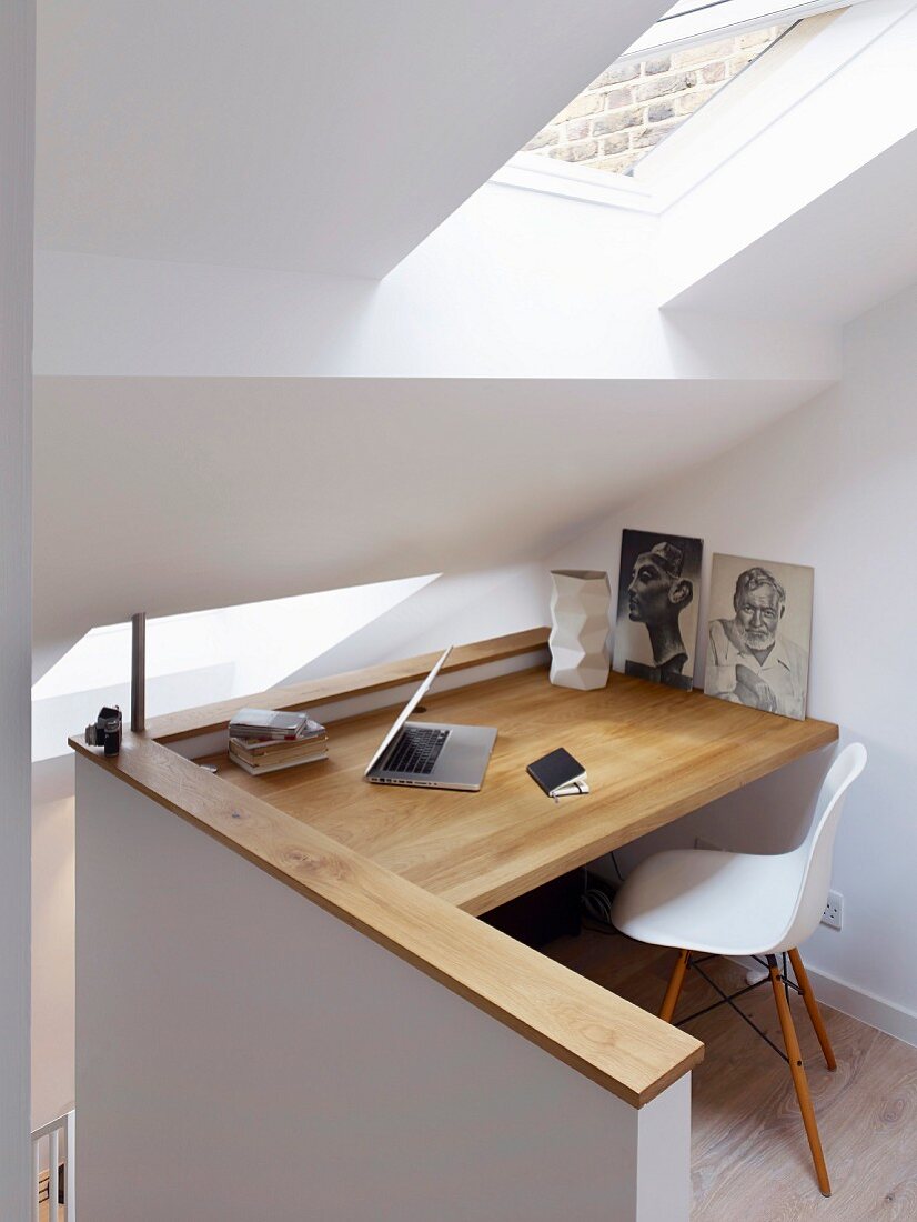 Custom study area with wooden desk below skylight