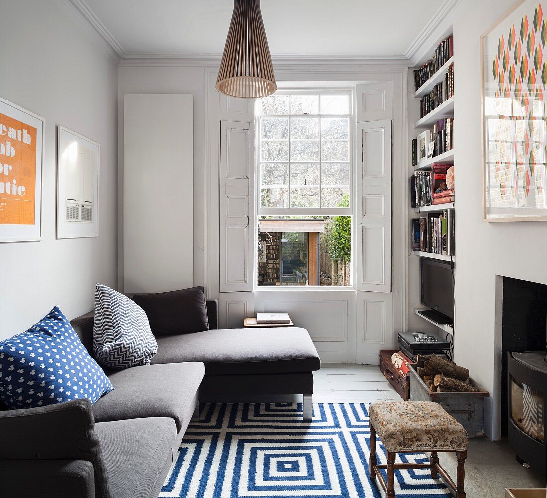 Bookcase, fireplace and sofa in comfortable living room