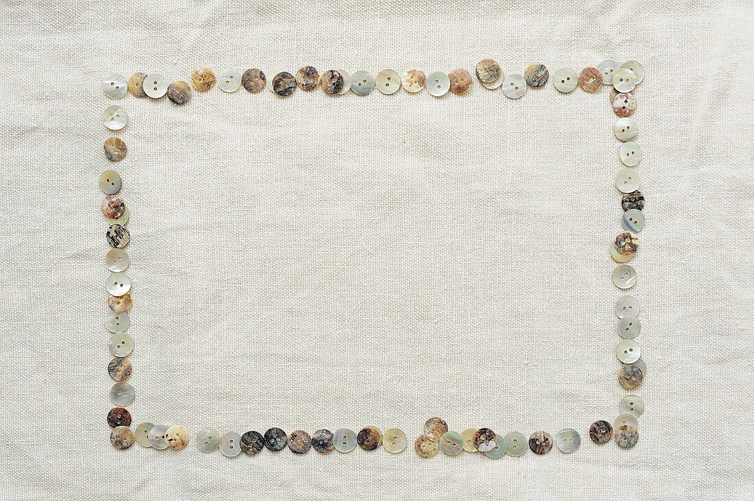 Frame made from mother-of-pearl buttons laid on linen cloth