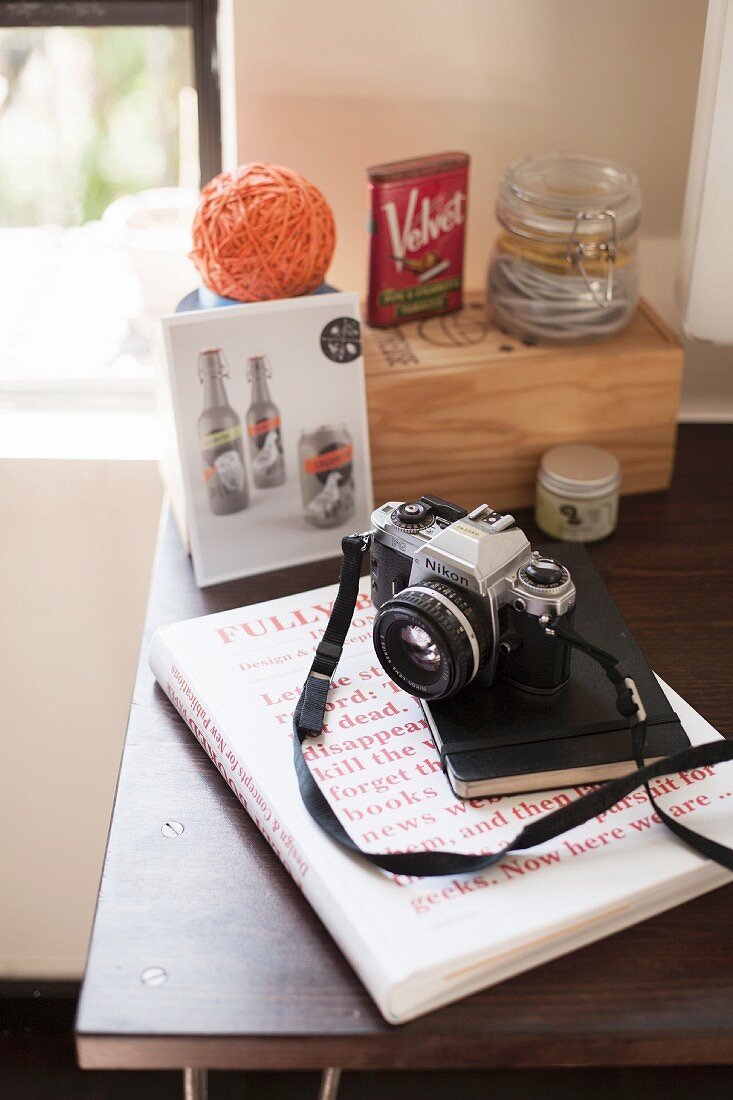 Camera and book on table