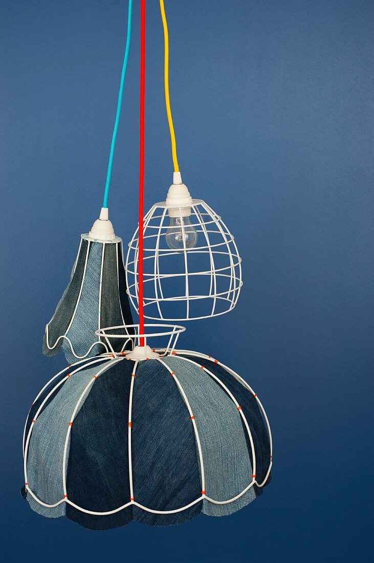 Wire lampshades lined with various shades of denim