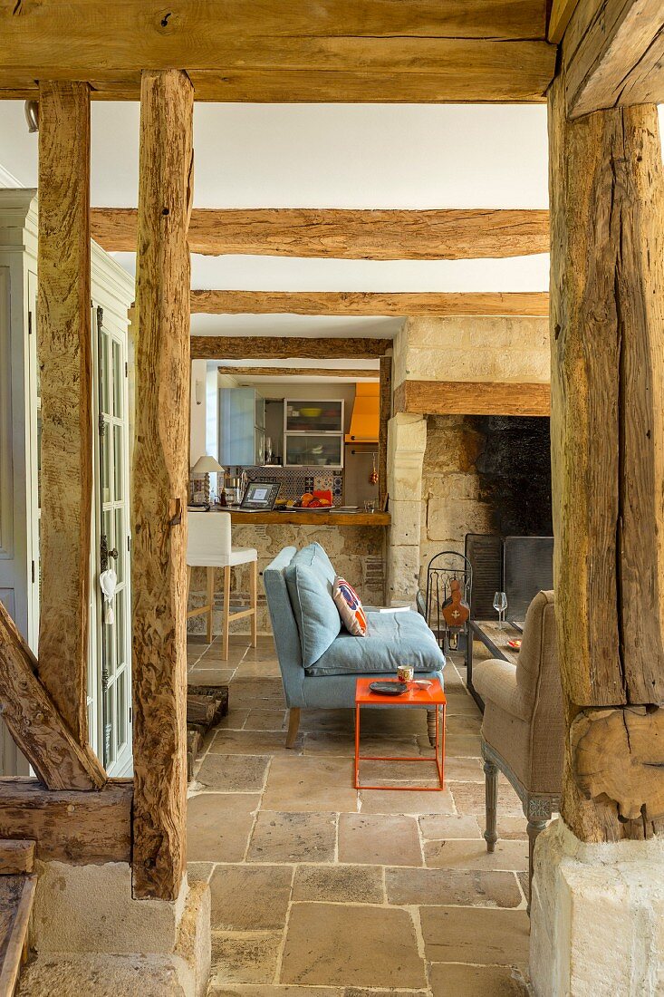 Rustic living area with stone floor and exposed beams