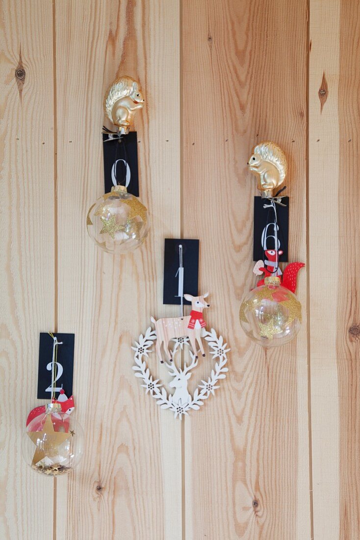 Christmas decorations and numbered signs hung on wooden wall