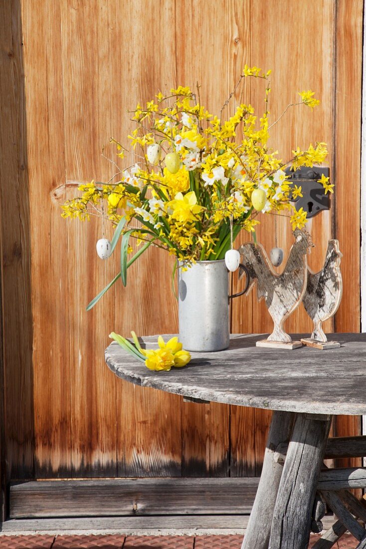 Yellow Easter arrangement of forsythia, narcissus and Easter eggs