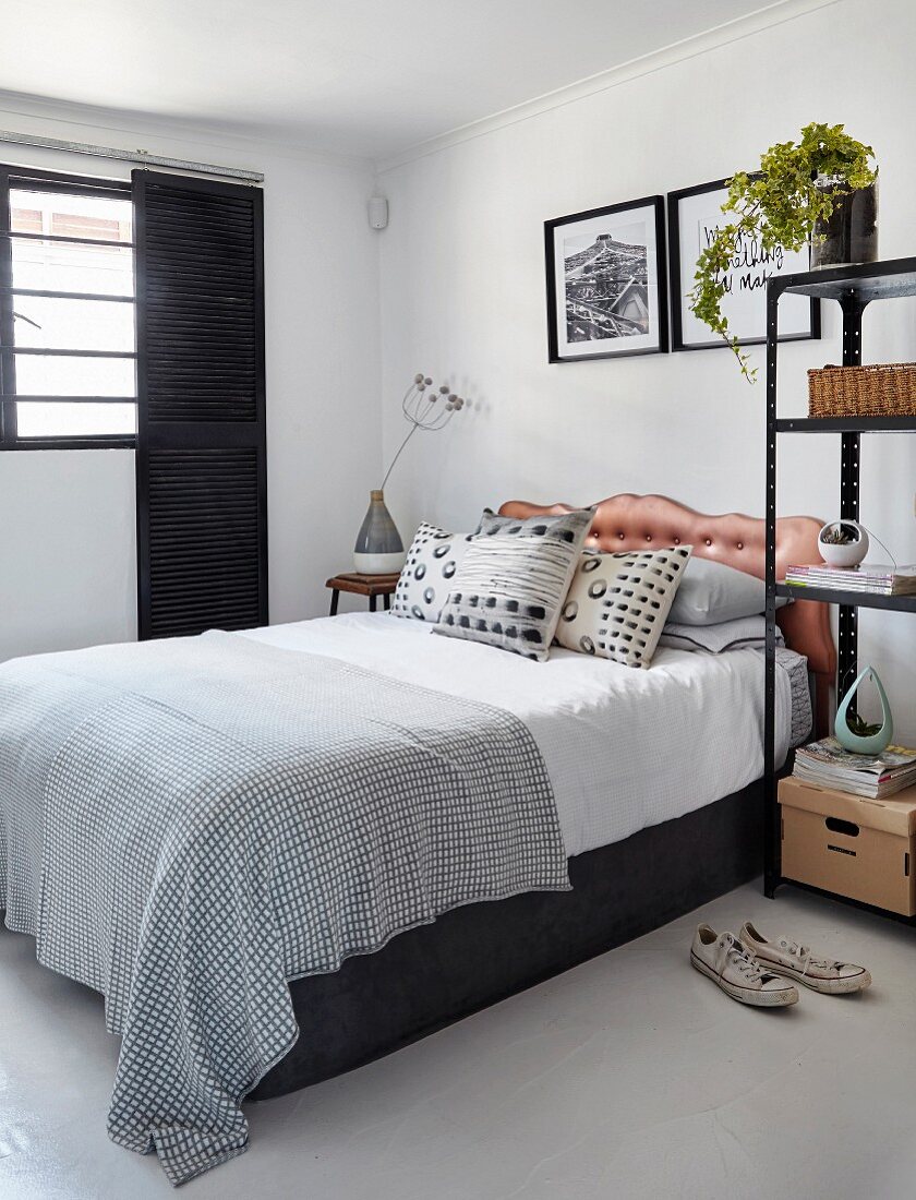 Modern black and white bedroom with button-tufted headboard