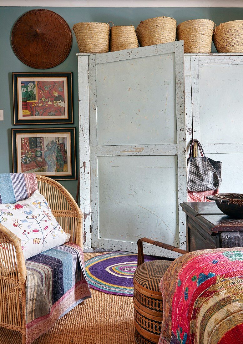 Baskets on top of vintage wardrobe in eclectic bedroom
