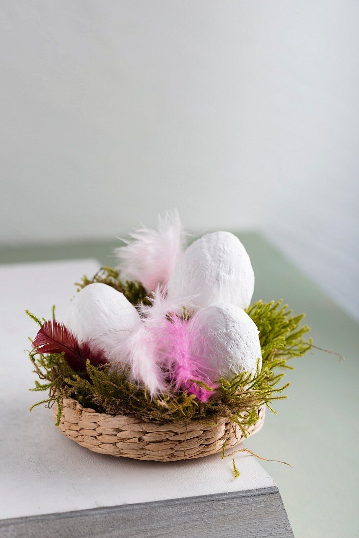 Hand-made Easter decorations: white eggs made from plaster bandages in Easter nest