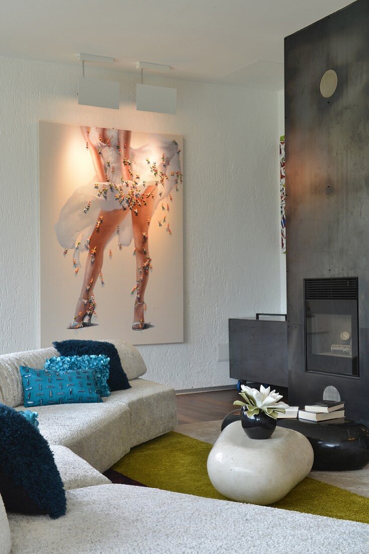 Fireplace, metal chimney breast and modern artwork in lounge area