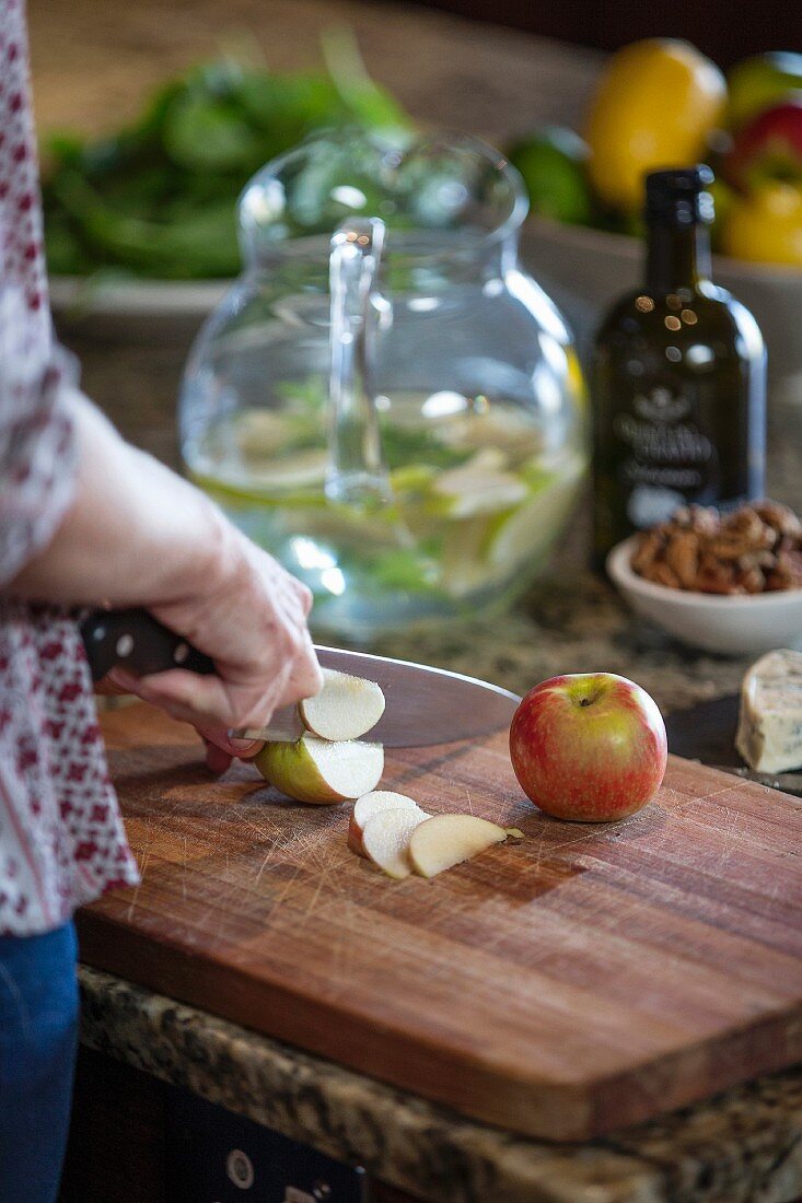 Slicing apples on rustic wooden board