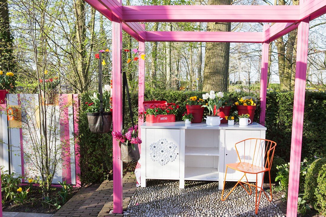 Pink pergola and dresser in garden