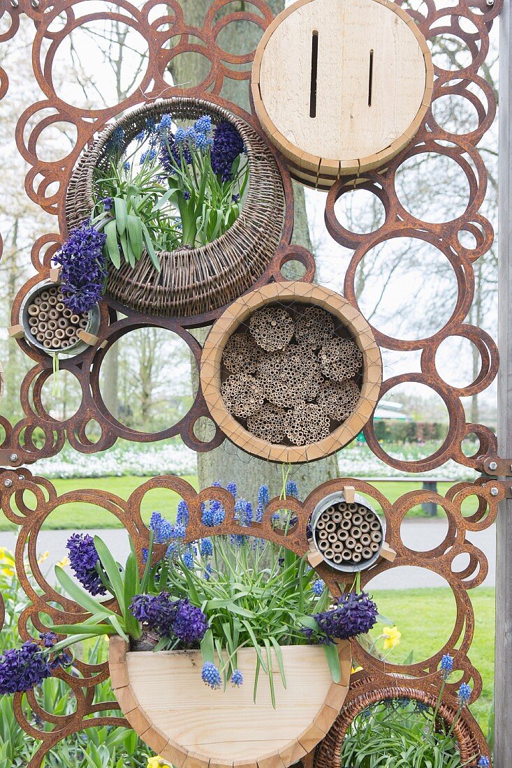 Rusty metal screen with circular motif and flowers