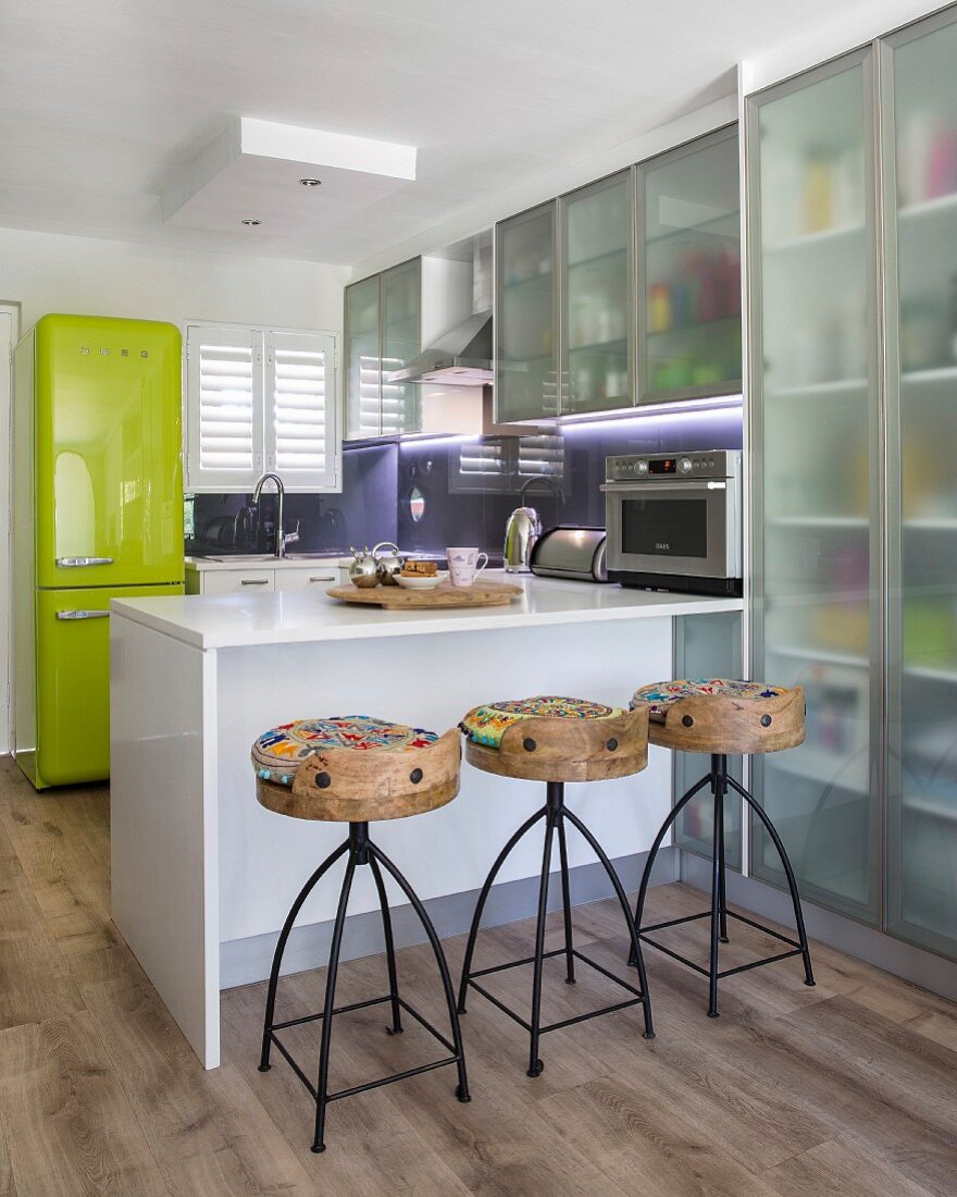 Translucent cupboards and breakfast bar in modern kitchen