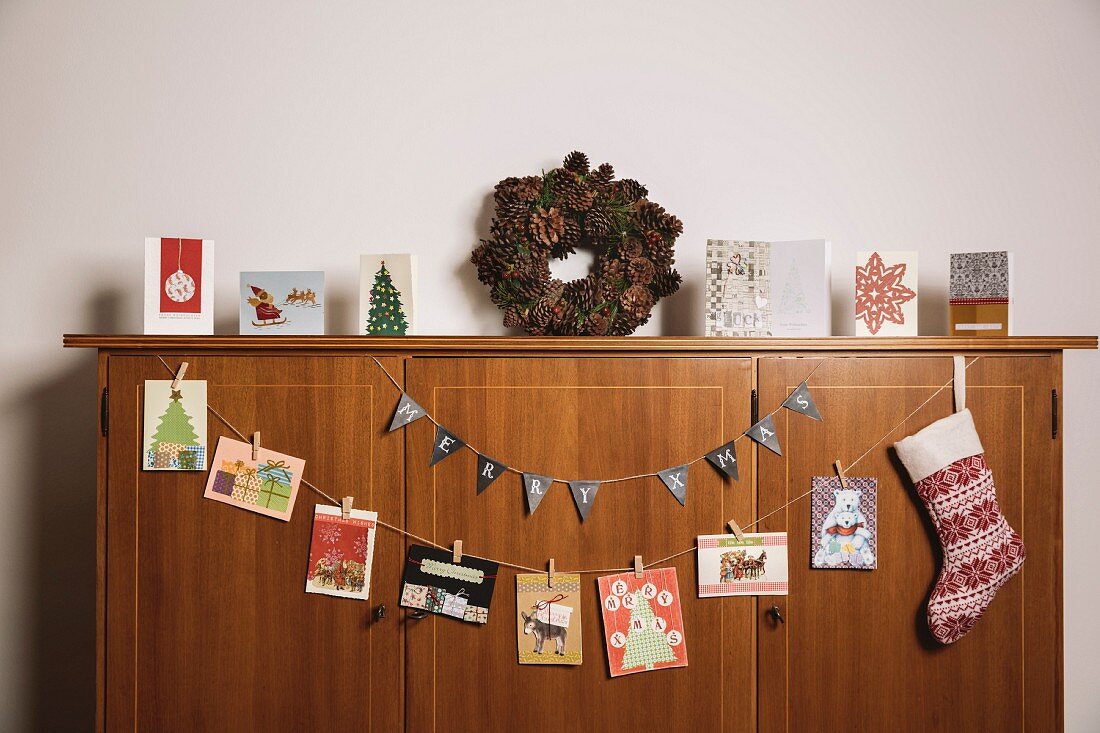 Christmas cards hung on wooden sideboard