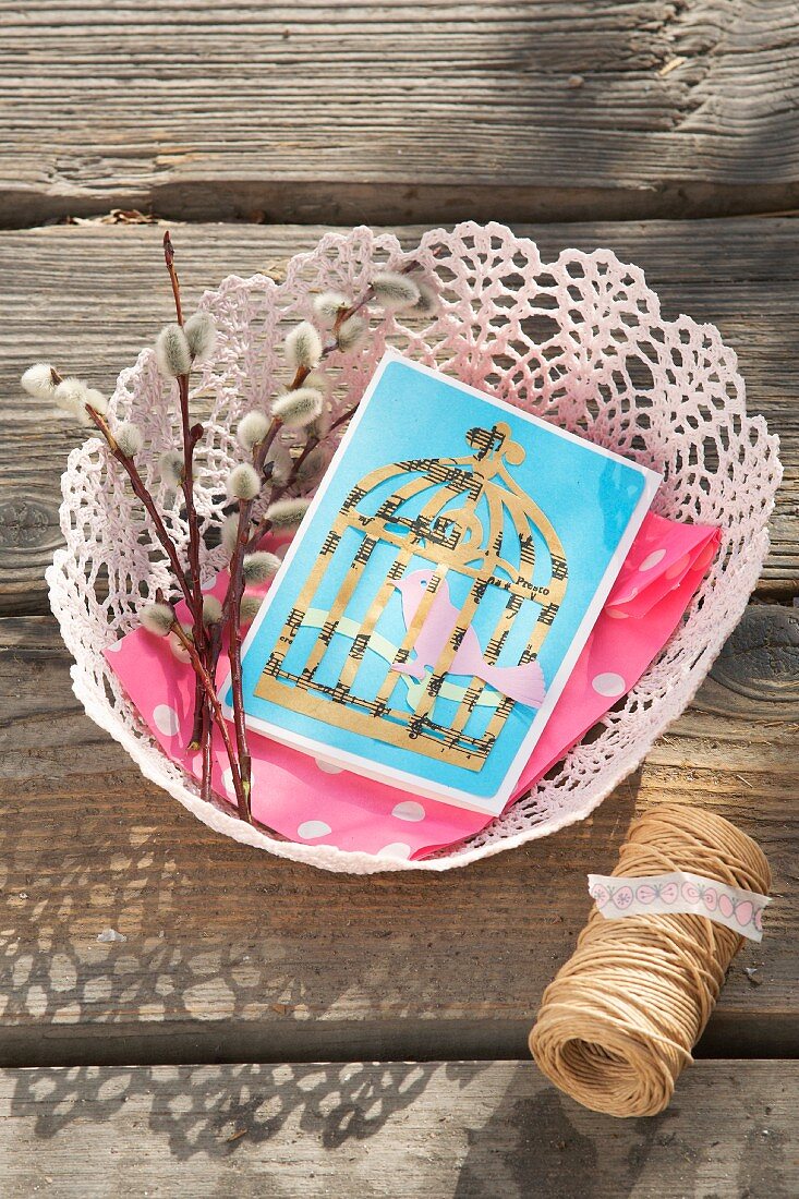 Hand-made card with picture of birdcage in lace basket