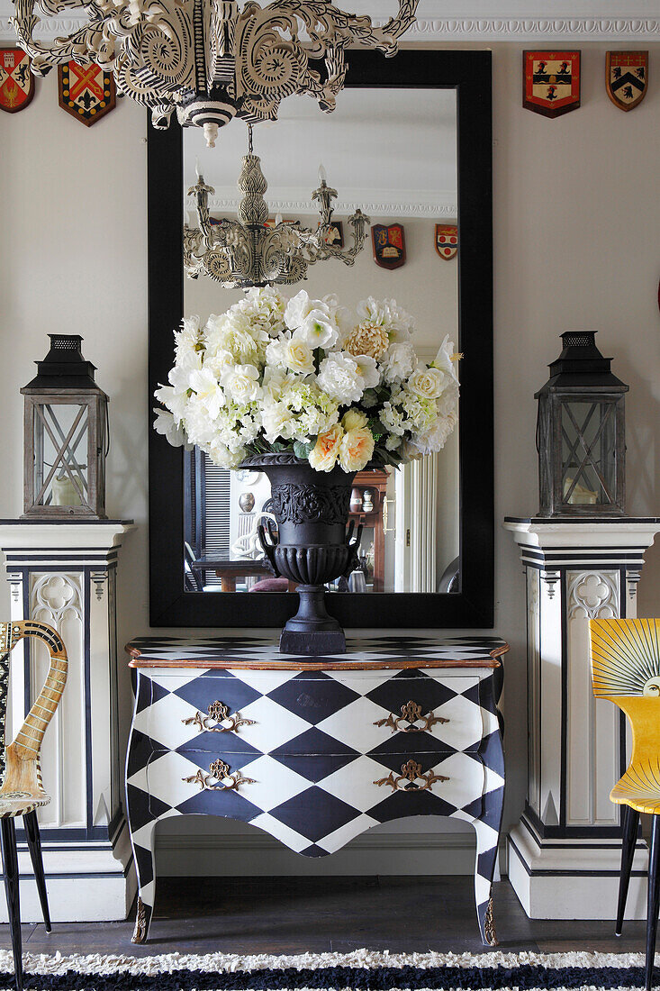 Ornate, square plinths and designer chair in artistic hallway