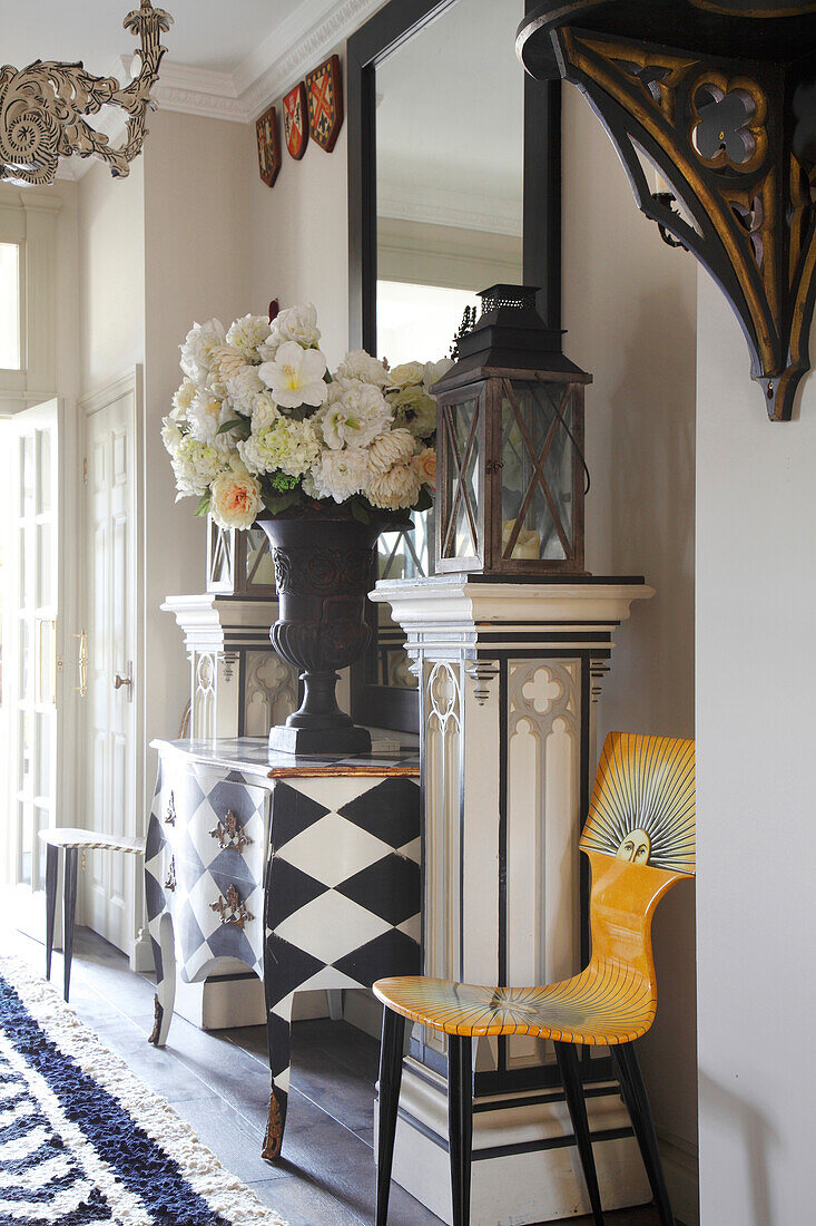 Ornate, square plinths and designer chair in artistic hallway