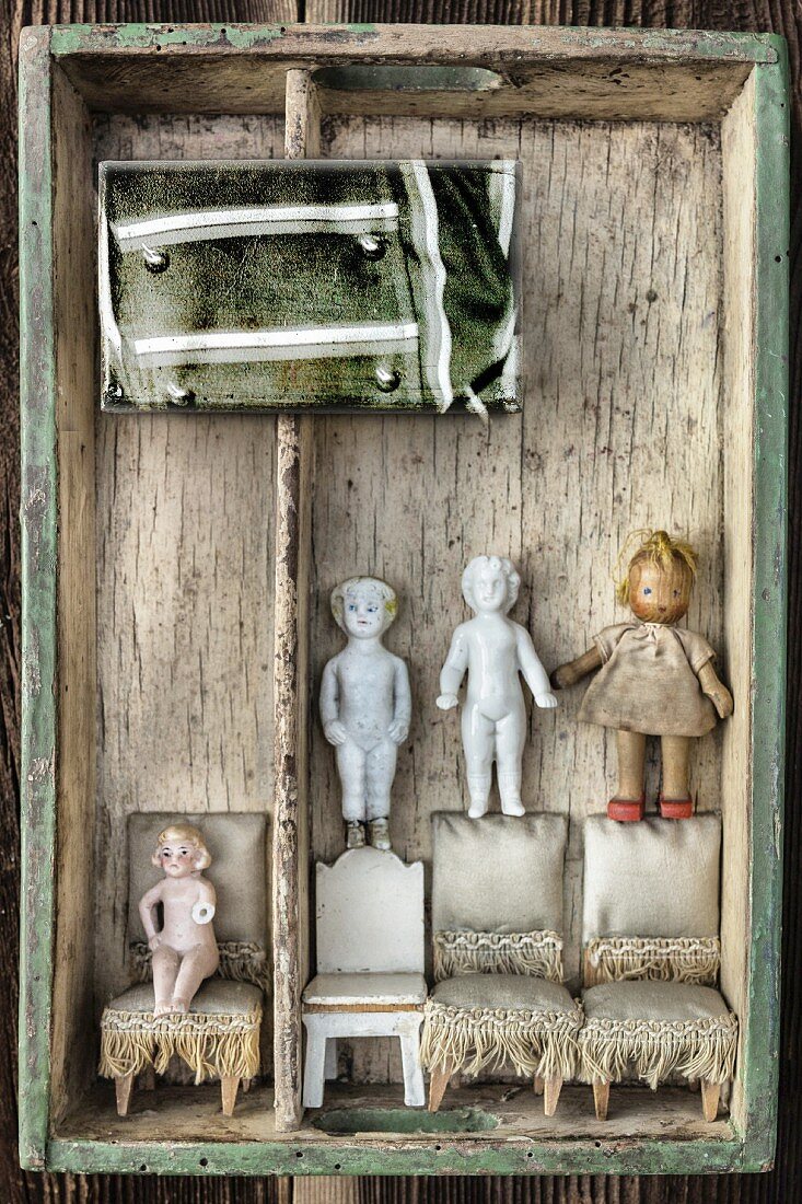 Dolls and dolls' furniture in vintage crate
