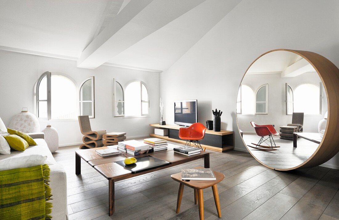 Large round designer mirror in living area