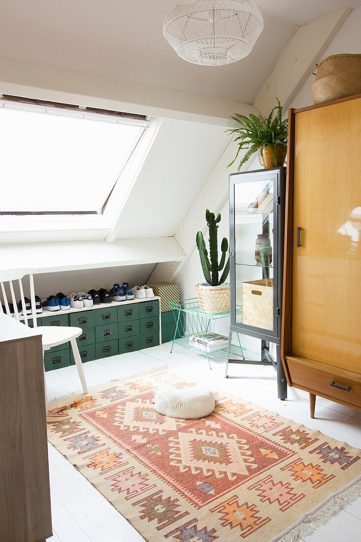Retro furniture in interior with skylight in sloping ceiling