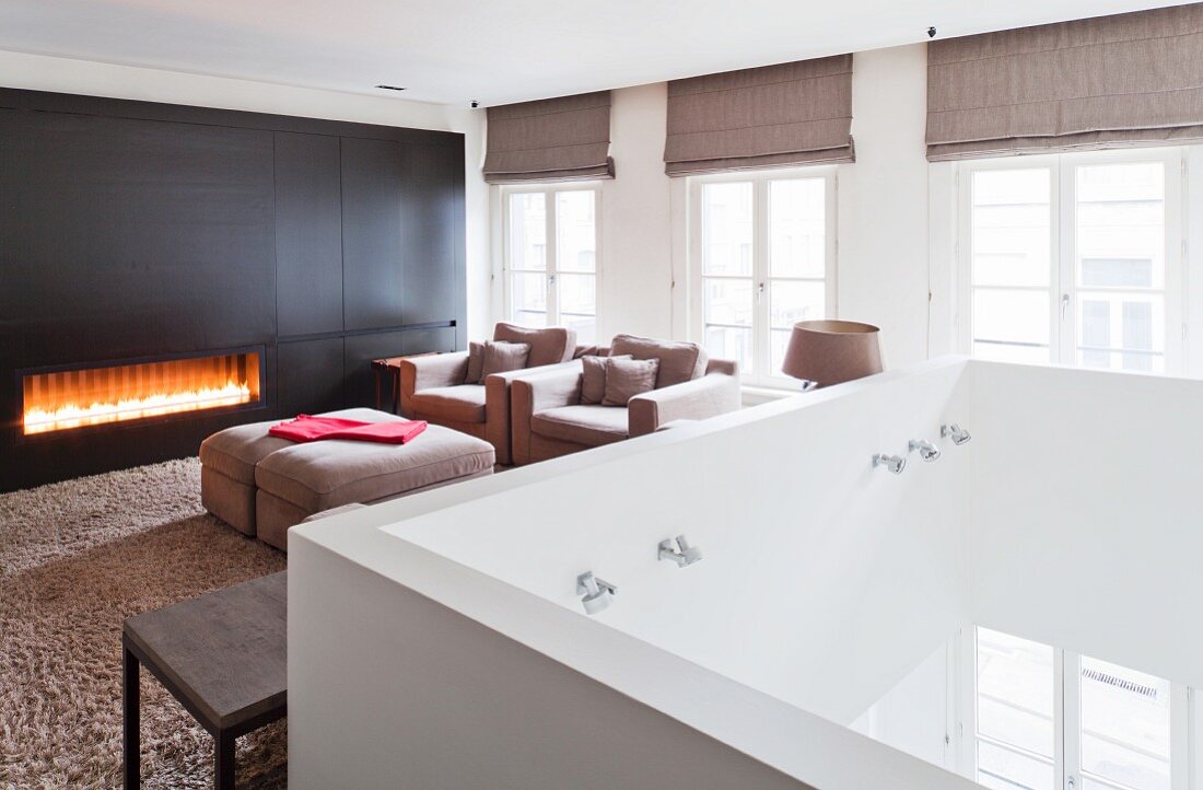 Gas fire in elegant lounge on gallery with white balustrade
