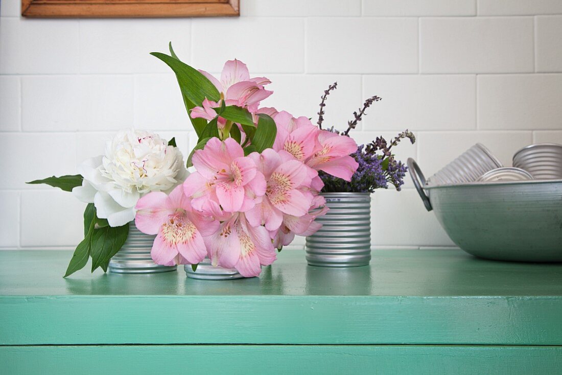 Peony, lilies and lavender in old tin cans