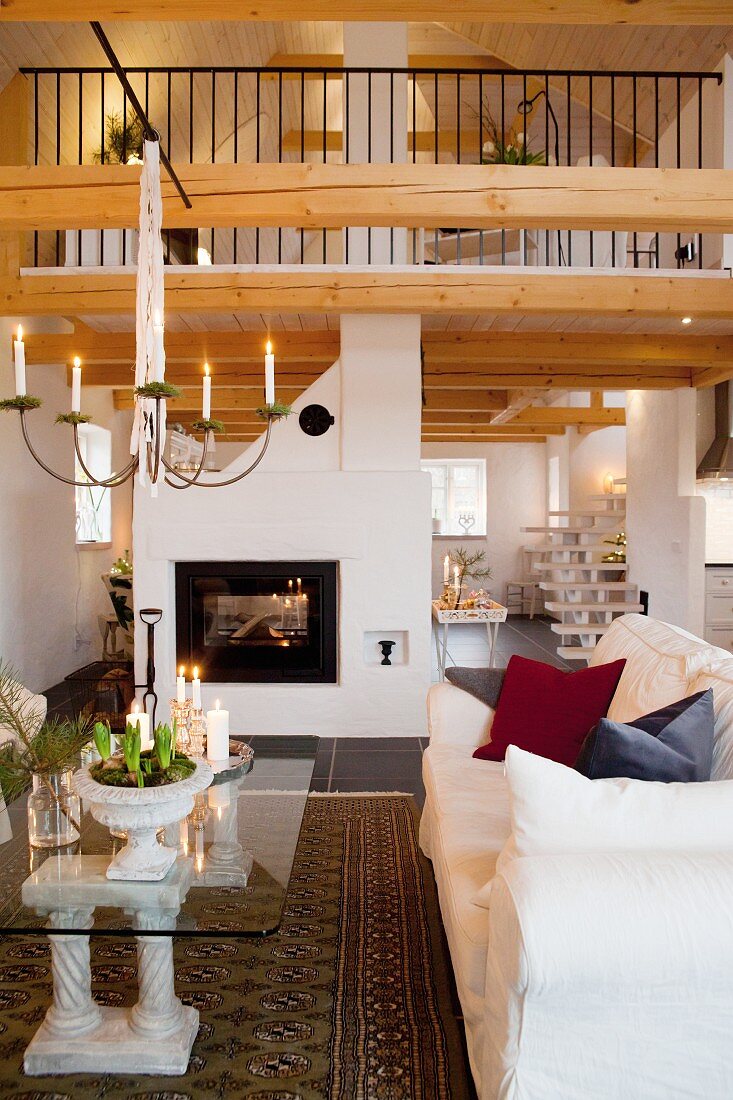 Fireplace, gallery and festive Advent atmosphere in open-plan living area of country house
