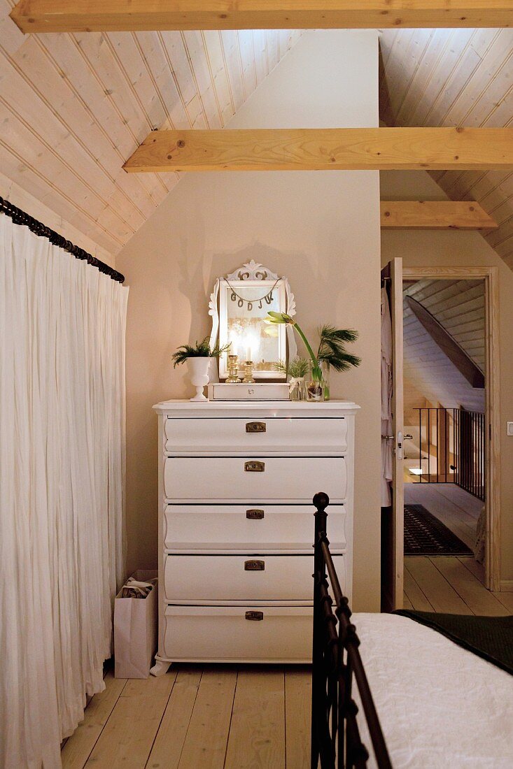 Christmas decorations on white chest of drawers in bedroom with vintage ambiance