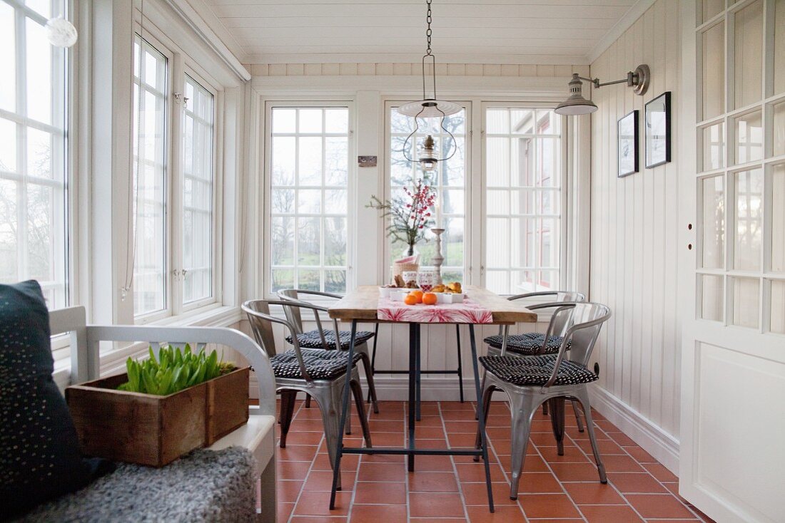 Rustic conservatory with lattice windows and dining table