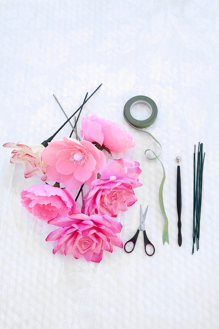Artificial flowers, tape and scissors