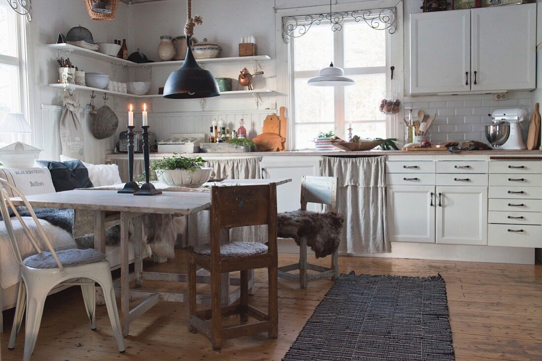 Rustikaler Esstisch in der weißen Wohnküche im Landhausstil