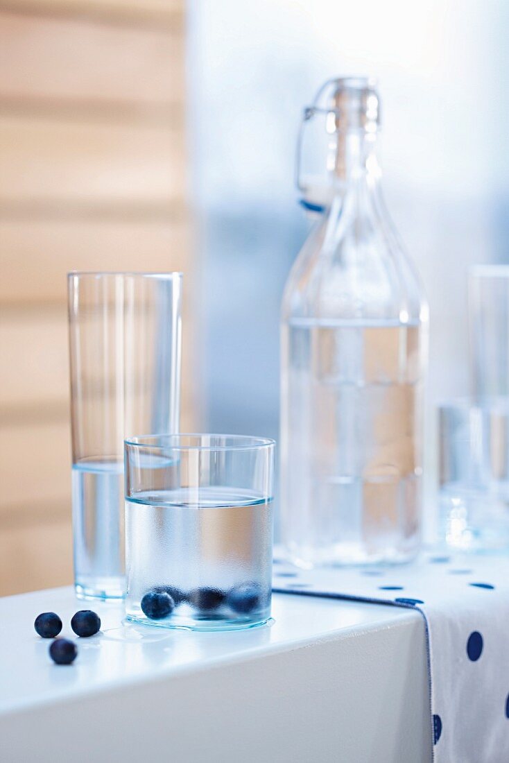 Glasses and carafes of water with blueberries