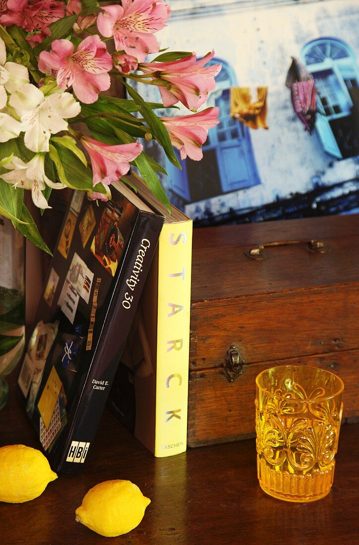 Books, flowers, lemons, drinking glass and wooden box