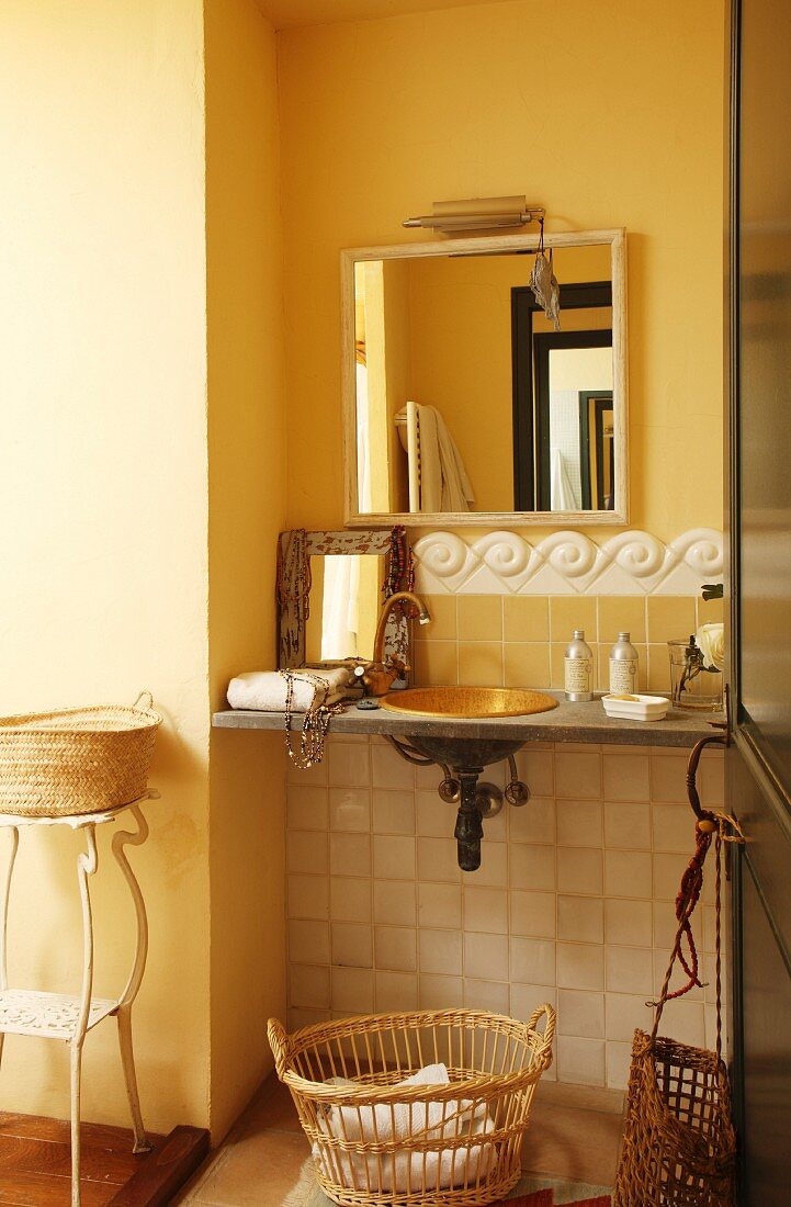 Bathroom accessories on vintage washstand with tiled dado rail and mirror