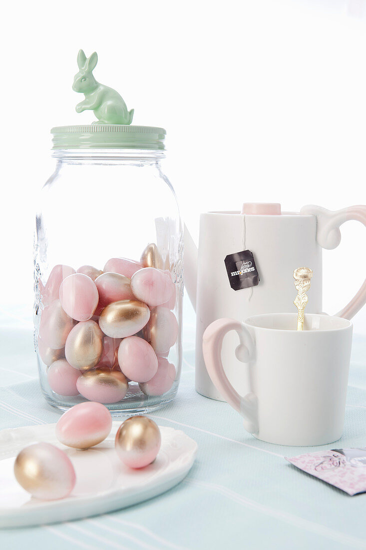 Pink and gold sugar eggs, teacup and teapot