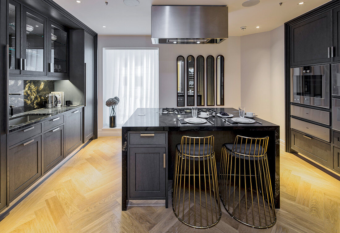 Elegant kitchen with black cabinets and island counter, Ten Trinity Square, London