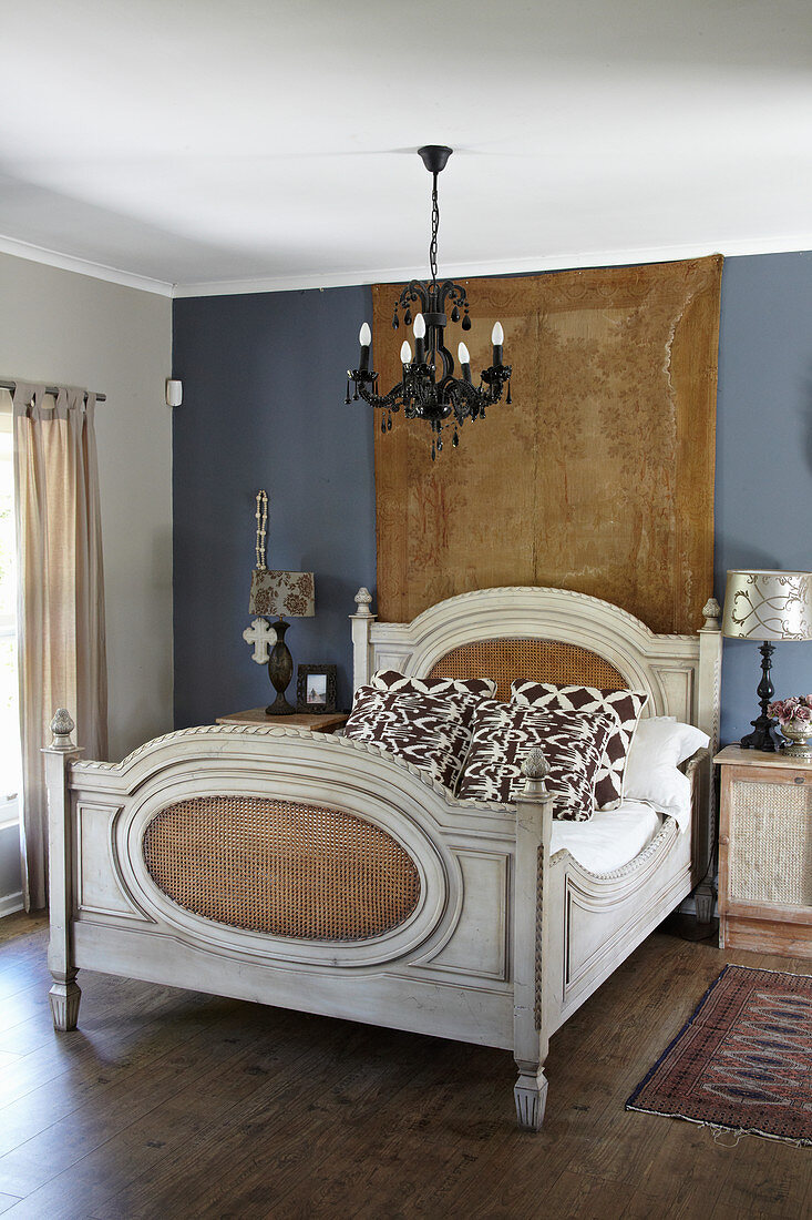 French sleigh bed in bedroom with slate-grey wall