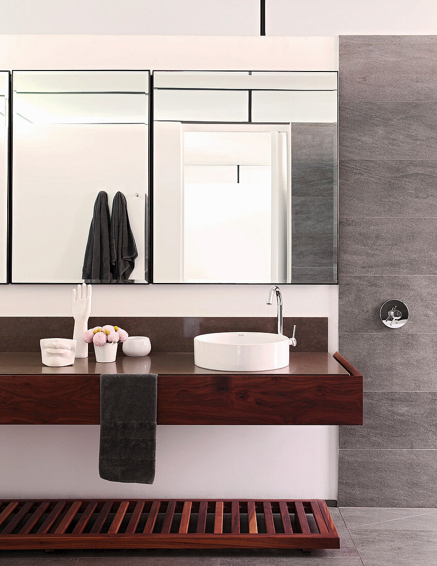Clear lines and wooden washstand in masculine bathroom