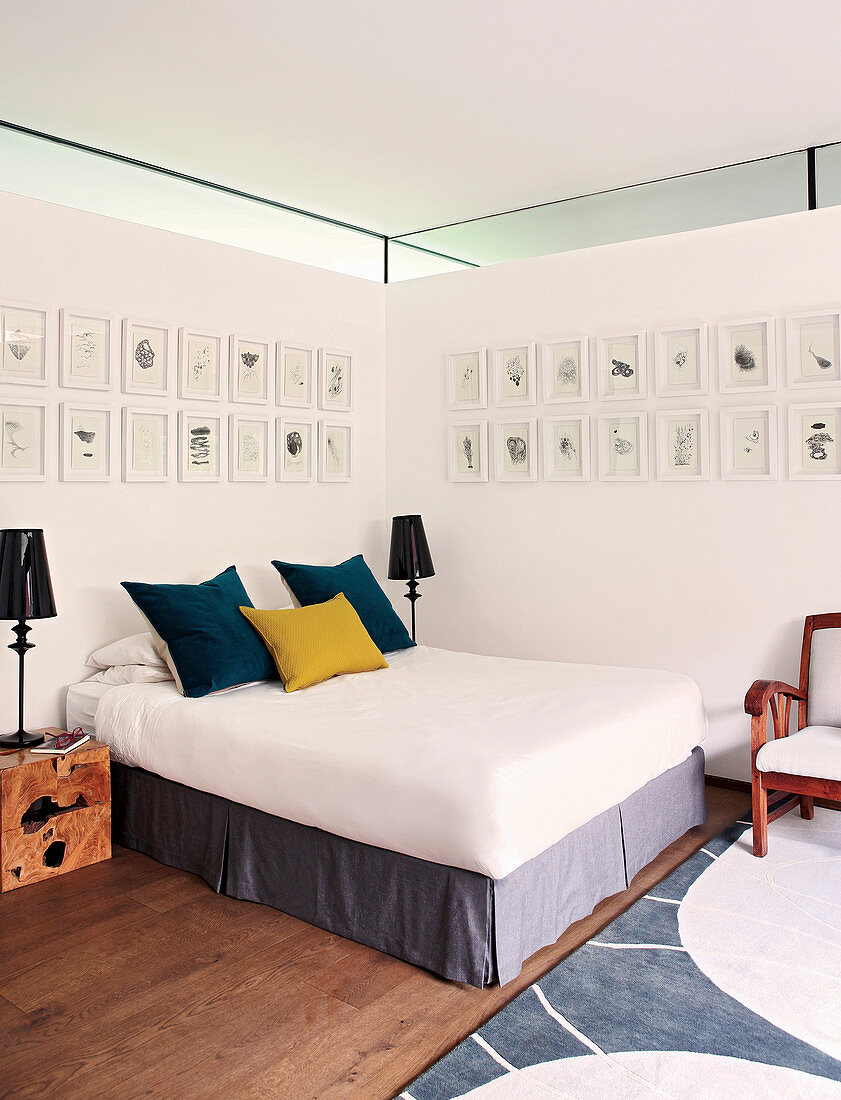 Bedroom with gallery of pictures on two walls and clerestory windows