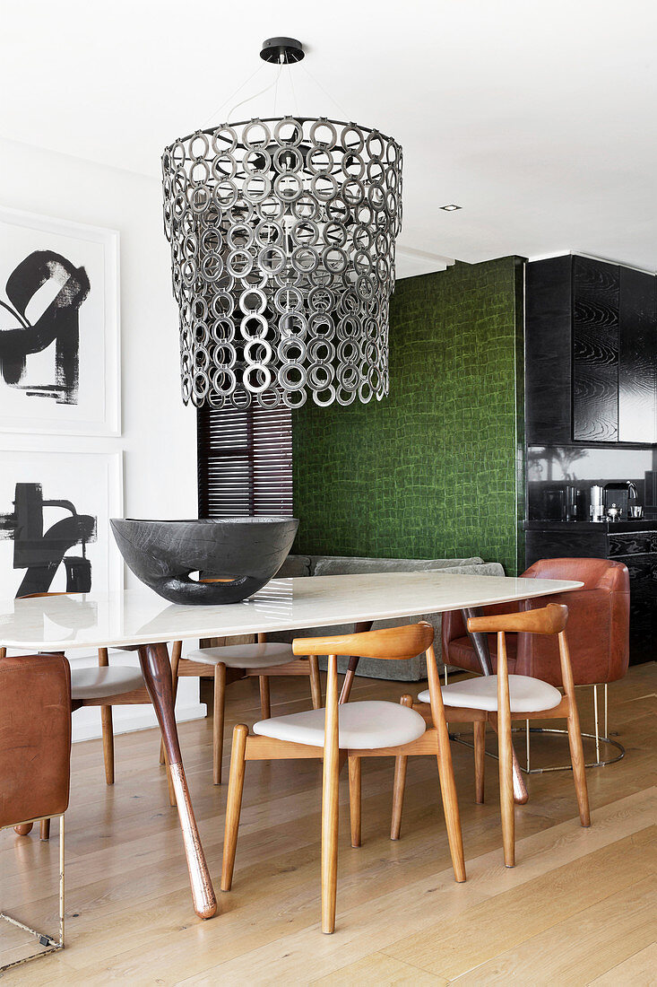 Dining table, designer chairs and chandelier