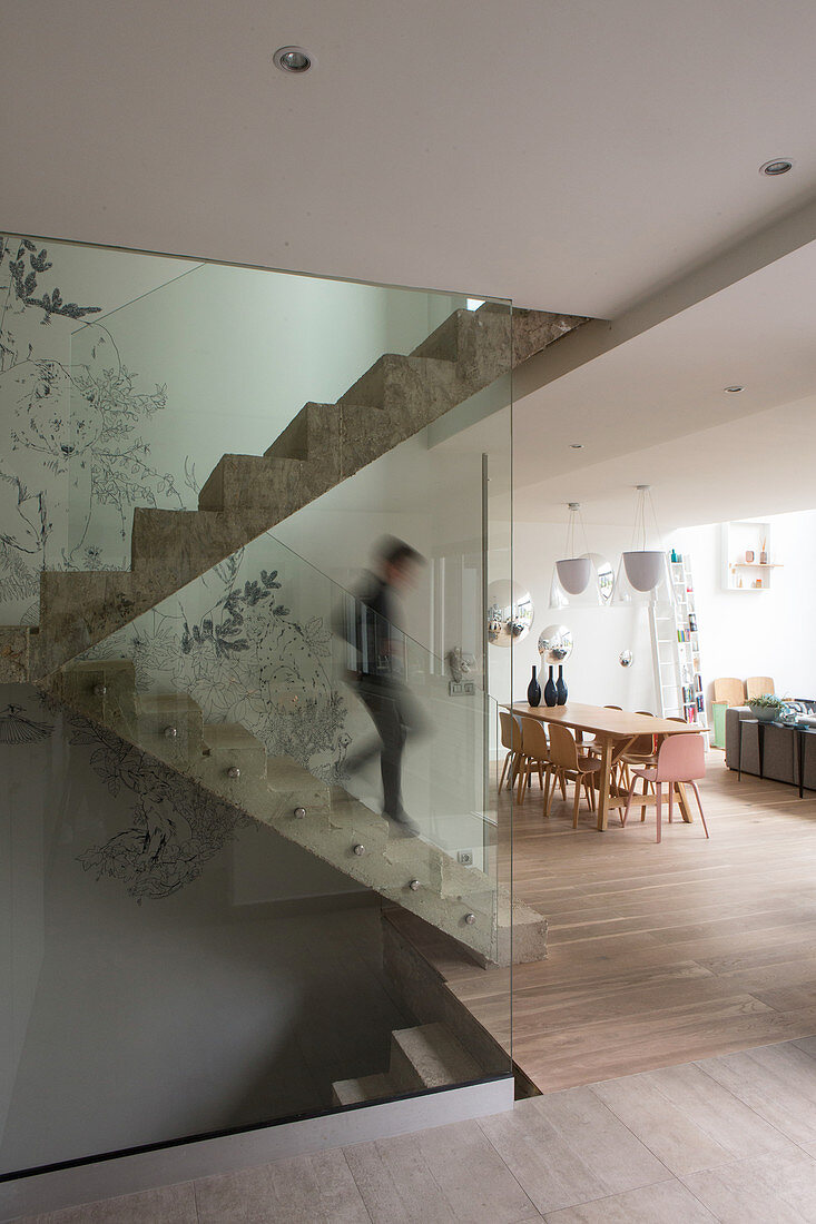 Concrete staircase with glass balustrade in modern apartment