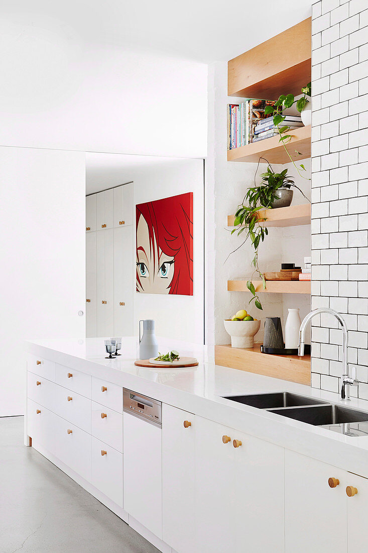 White kitchen unit, wooden shelves installed above