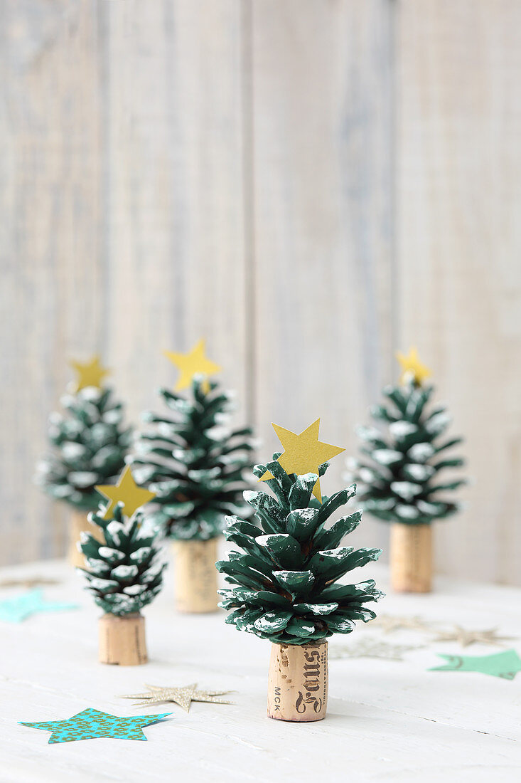 Christmas trees hand-crafted from pine cones painted green stuck on corks