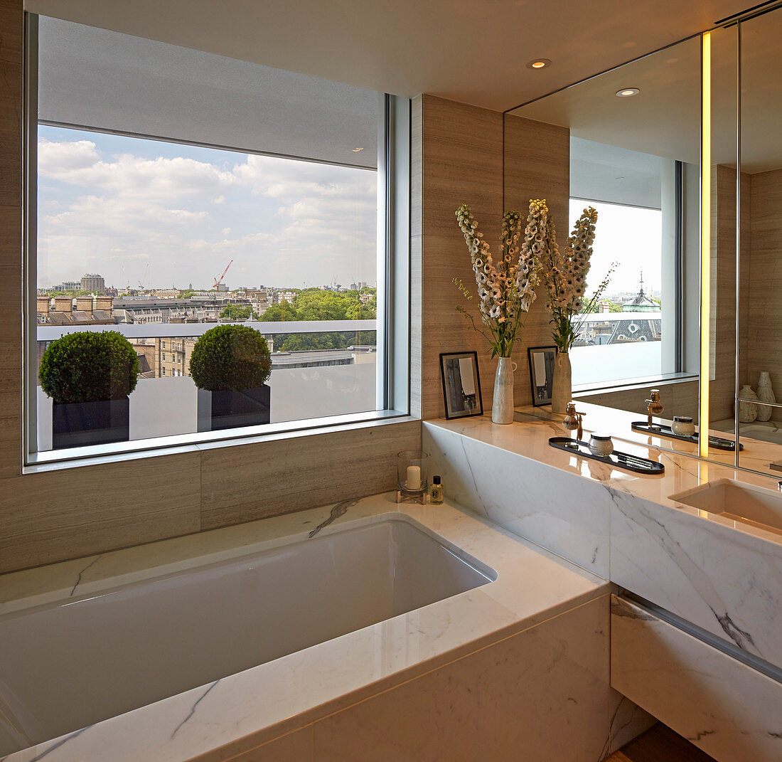 Luxurious bathroom with marble cladding and view of London