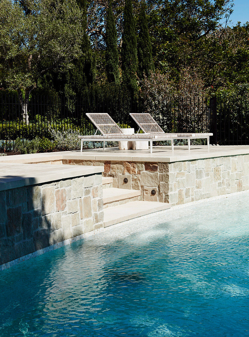 Natural stone terrace with pool and sun beds